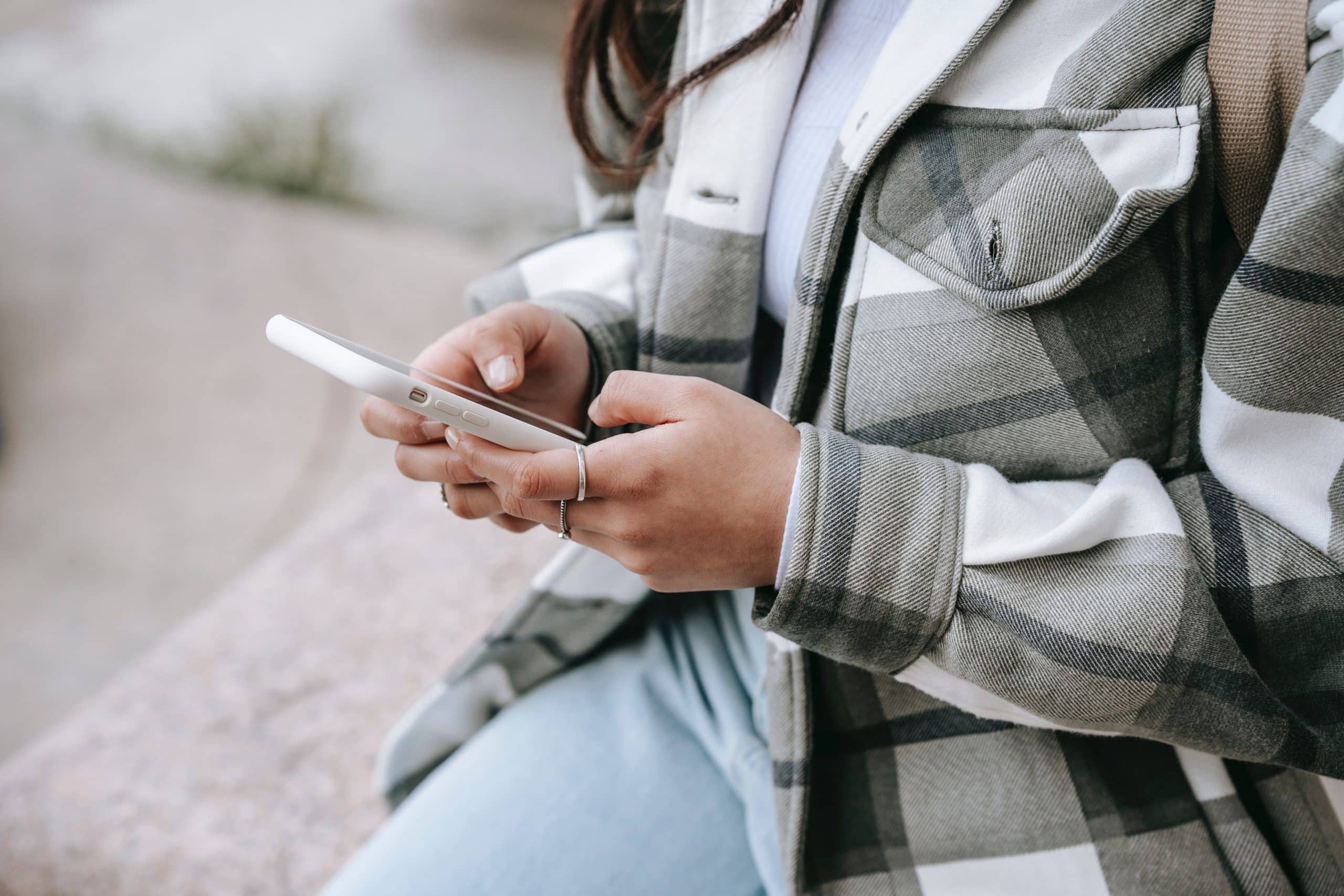 Woman looking at a mobile phone. Featured image for podcast episode "Why do we develop bad habits?"