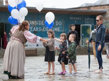Image of children receiving Oxford Preservation Trust balloons at Oxford Open Doors