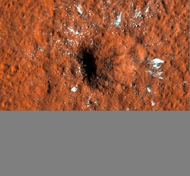 A crater on the surface of Mars imaged by the Mars Reconnaissance Orbiter. Image credit: NASA/JPL-Caltech/UArizona.