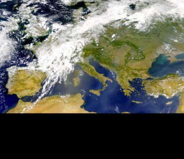 The image shows a satellite image over Europe with clouds visible. Image credit: Shutterstock.