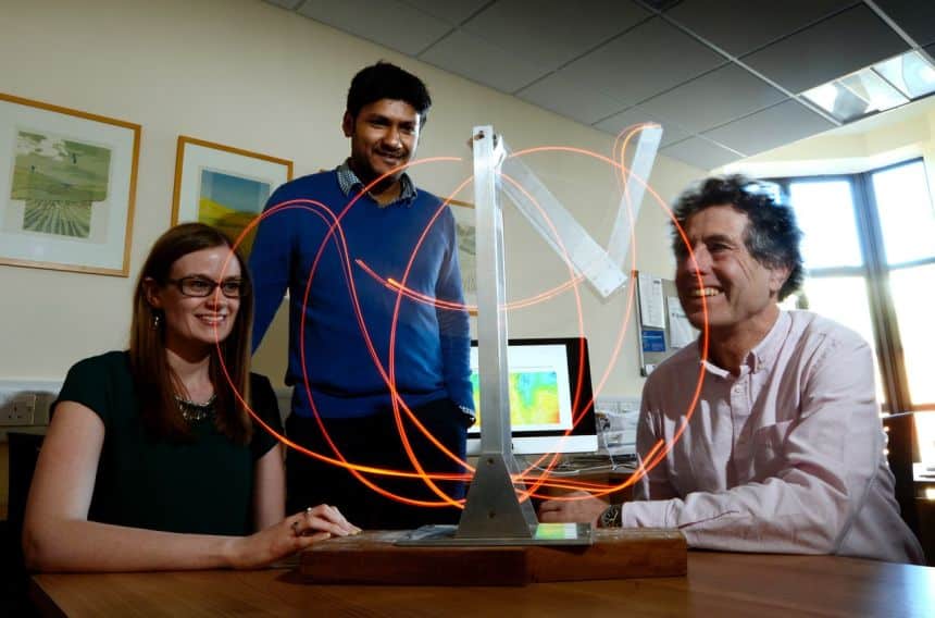 Professor Tim Palmer and two members of his group studying the chaotic motion of a double pendulum.