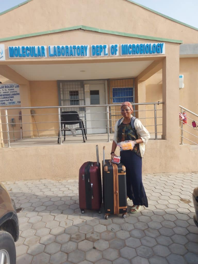 Chinenye Akpulu in front of a lab in Nigeria