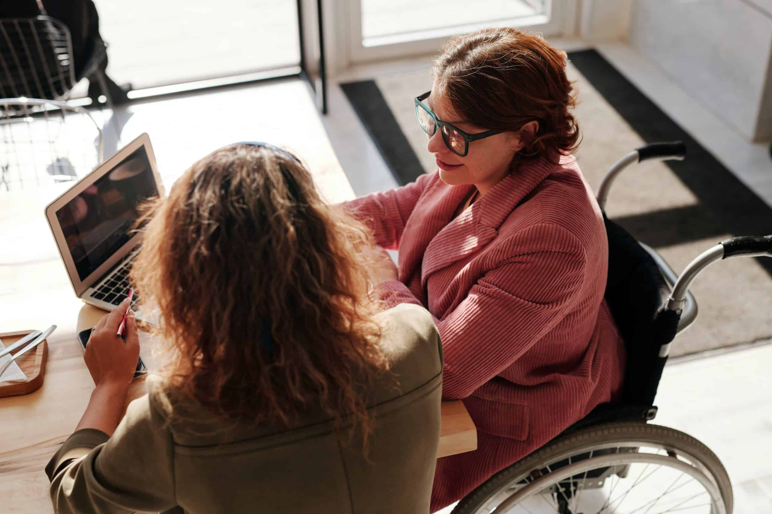 Two women looking at a computer screen. Featured image for podcast episode "Why do research on research?"