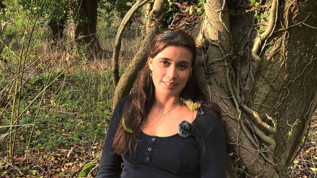 Charlotte Collingwood sits against a tree. Featured image for the video 'When Stress Turns Bad'.