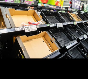 Empty crates in a supermarket fruit and vegetable section. Image credit: Shutterstock. 