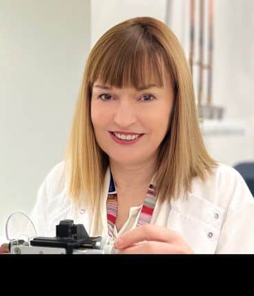 A head and shoulders portrait photograph of Carol Robinson.