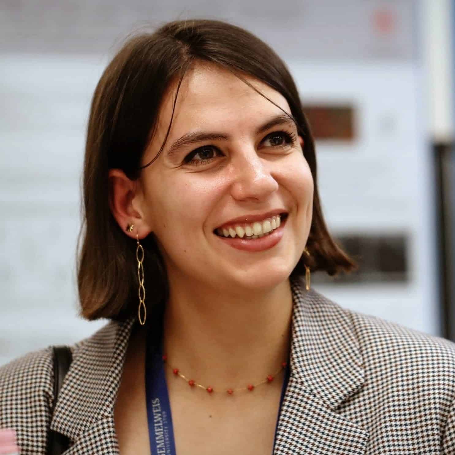 Young woman wearing a blazer and smiling