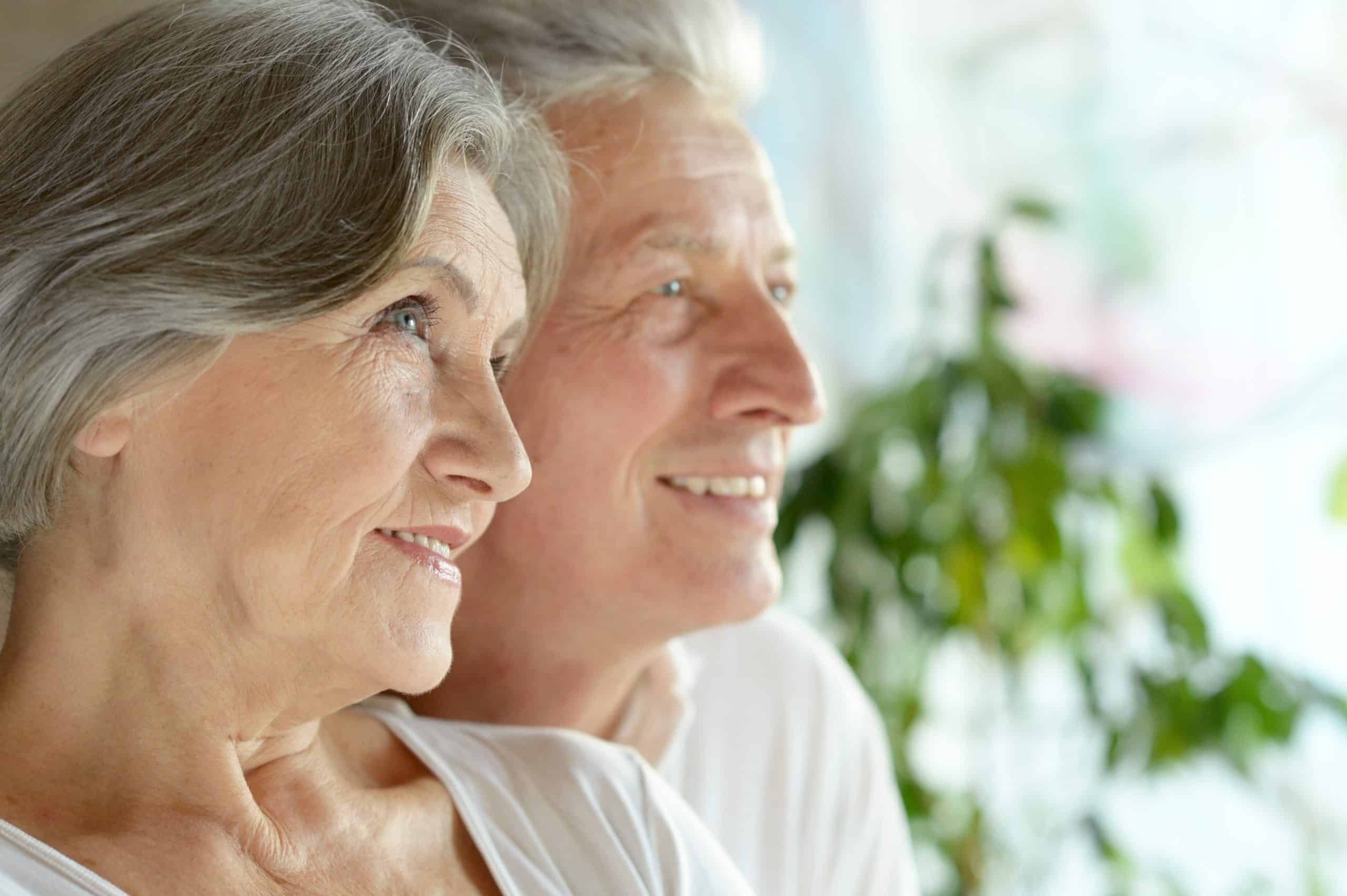 A woman and man, smiling.