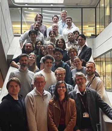 A diverse group of men and women on a staircase.