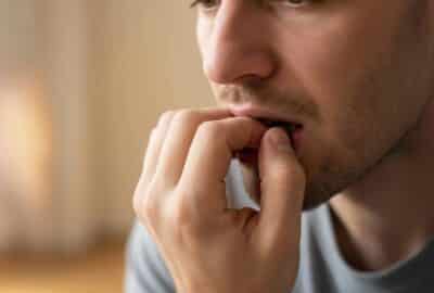 AI-generated image of a man biting his nails.