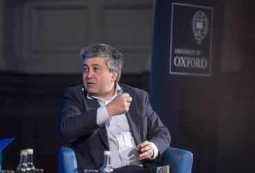 Image depicts an animated Sunder Katwala sharing views as a panellist at the Sheldonian Series event on October 21