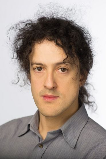 Portrait of Professor Phiip Torr, a white man with curly black hair.